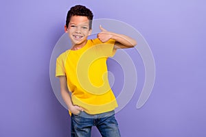 Photo of positive nice boy wear yellow trendy clothes thumb up cool feedback nice quality isolated on purple color