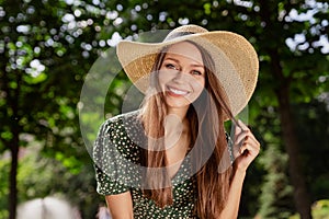 Photo of positive nice charming happy woman smile wear hat good mood enjoy spring outdoors outside park