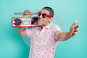 Photo of positive nice man carry boombox have fun arm welcome invite you isolated on teal color background