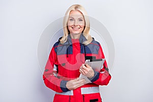 Photo of positive pretty happy nice old woman ambulance worker hold tablet isolated on grey color background