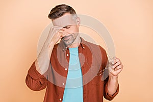 Photo of pressured middle-aged guy touch nose suffer covid illness isolated over pastel beige color background