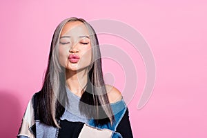 Photo of pretty adorable coquettish girl closed eyes pouted lips kiss empty space isolated on pink color background