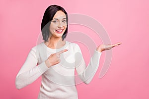 Photo of pretty business lady indicating finger on open palm presenting novelty wear white pullover isolated pink bright