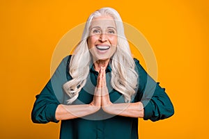 Photo of pretty cheerful white haired grandma lady holding hands together excited feelings beg children stay guests