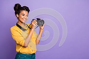 Photo of pretty dark skin lady holding photo digicam in hands photographing foreign sightseeing professional wear yellow