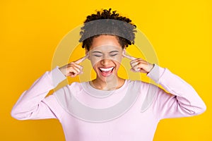 Photo of pretty dark skin people closed eyes fingers in ears open mouth isolated on yellow color background