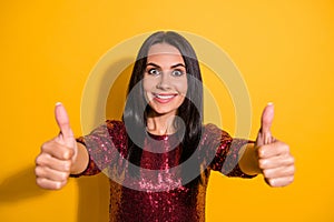 Photo of pretty lady in best party mood raising thumbs up agree to start chill wear shine red dress isolated yellow