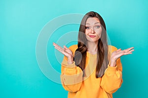 Photo of pretty lady shrugging shoulders dont know answer isolated on cyan color background