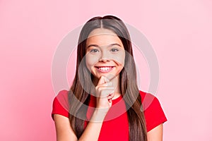 Photo of pretty latin kid girl toothy smiling in camera touch chin wear red t-shirt isolated over pastel color