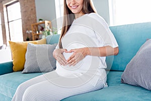 Photo of pretty lovely cute gentle tender girl sitting on couch enjoying beautiful period pregnancy showing heart love