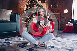 Photo of pretty lovely girl dressed ornament jumper sitting on fluffy carper decorated room cozy atmosphere home magic