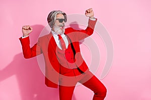 Photo of pretty lucky man pensioner dressed red jacket dancing rising fists empty space isolated pink color background