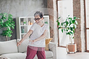 Photo of pretty retired woman have fun dance wear white outfit home flat rest relax spend free spare time living room