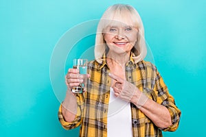 Photo of pretty senior woman indicate finger aqua recommend select isolated over teal color background