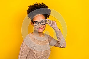 Photo of pretty young brunette lady wear eyewear beige pullover isolated on yellow color background