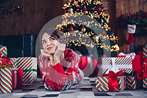 Photo of pretty young girl lying floor dreamy wondered look wear trendy red sweater festive interior living room