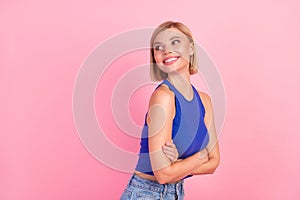 Photo of pretty young woman look empty space dream wear blue top isolated on pink color background