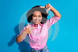 Photo of pretty young woman show cadre gesture face wear pink shirt isolated on blue color background