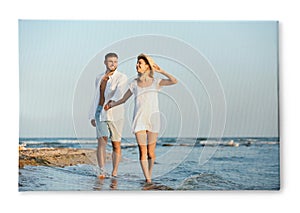 Photo printed on canvas, white background. Happy young couple on beach