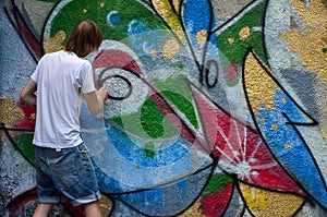 Photo in the process of drawing a graffiti pattern on an old concrete wall