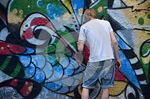 Photo in the process of drawing a graffiti pattern on an old concrete wall