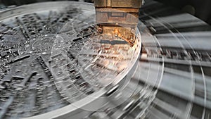 Photo of the production process metal processing with a cutter in the block holder on a circular faceplate rotating with great