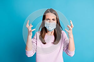 Photo of provoked young lady raise hands wear blue face mask isolated blue color background