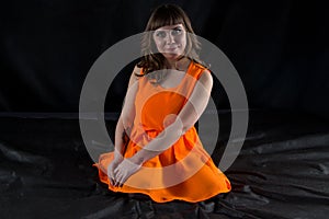 Photo of pudgy woman in orange dress