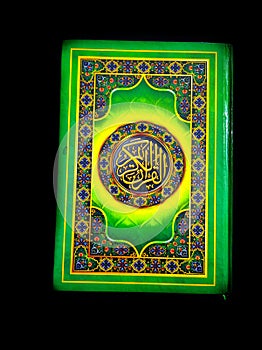 A photo of the Quran ready for Ramadan.  Arabic on the cover is translated as the Qur'an