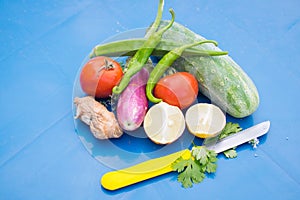 Photo about raw vegetables on blue background. Vegetables on table