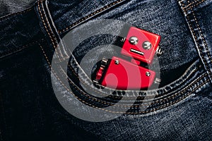 Photo of red robot toy in pants pocket