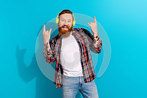 Photo of redhair beard businessman hipster rock roll music show brutal fingers listen wireless earphones isolated on