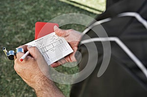 Photo of referee writing report