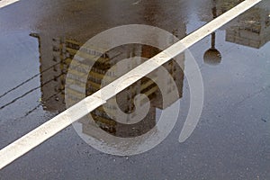 Photo of a reflection modern house in an autumn puddle.