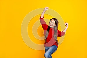 Photo of rejoicing shouting cute amazing schoolgirl overjoyed with victory and glory she gained wearing jeans denim red