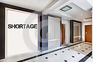 Photo of rental apartment business interior with shortage sign on the wall