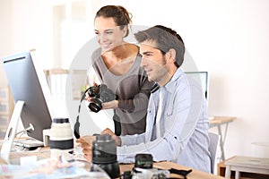 Photo reporters working on computer photo