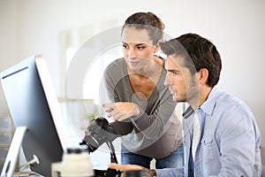 Photo reporters working on computer