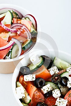 Photo for restaurant menu. Greeck salad and cesar salad isolated on white background. top view