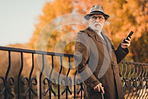 Photo of retired grey hair moody grandpa man walk park stick read email telephone doctor prescription serious look side