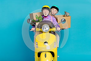 Photo of retired grey haired pensioner couple biker ride hold box move house amazed husband wife isolated on blue color