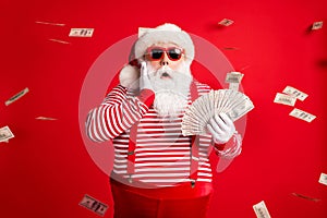 Photo of retired old man grey beard hold cash fan hand cheek shock money wear santa x-mas costume suspenders sunglass