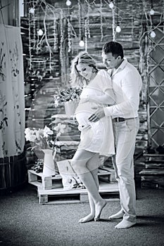 Photo in retro style. loving husband looking at his pregnant wife`s tummy