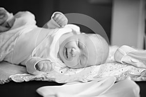 Photo in retro style. newborn baby lying on the changing table