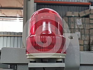 Photo of revolving light or factory industry red alert emergency light.