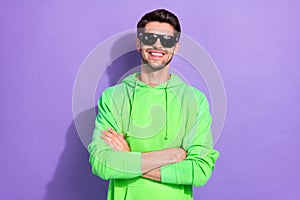 Photo of rich positive influencer hold folded hands wear green pullover expensive sunglasses rayban nightclub isolated
