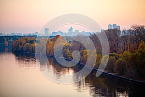 Photo of river, trees, evening city .