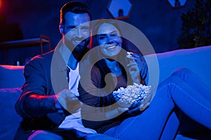 Photo of romantic bonding couple lady guy sit couch eat pop corn switch tv series in dark night apartment