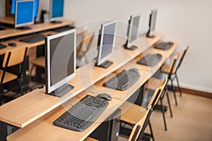 Photo of row computers in classroom or other educational institution
