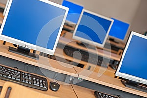 Photo of row computers in classroom or other educational institution